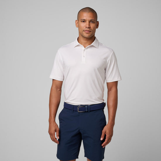 White short-sleeve polo shirt with collar and button front, styled with navy shorts and belt.
