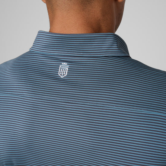 Men's polo shirt with horizontal blue and gray stripes and small emblem on back collar.