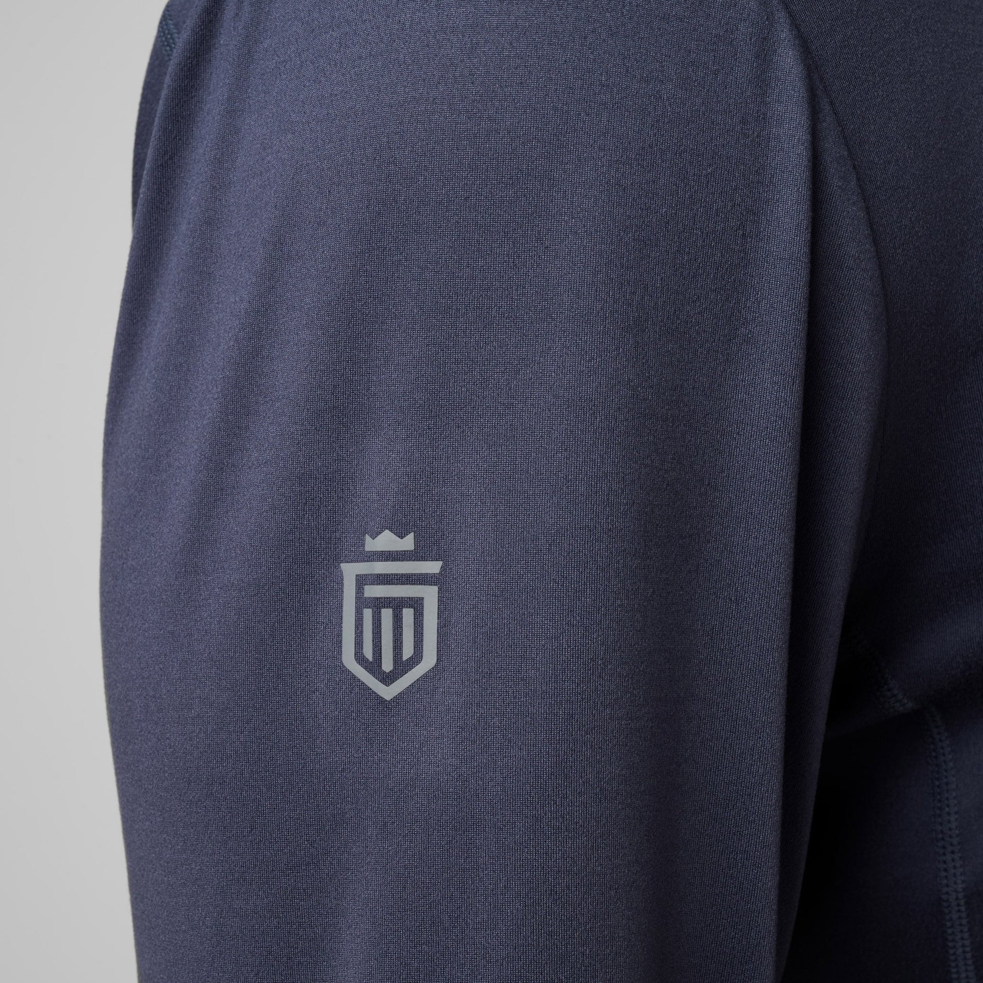 Navy blue quarter zip pullover with small shield logo on chest.