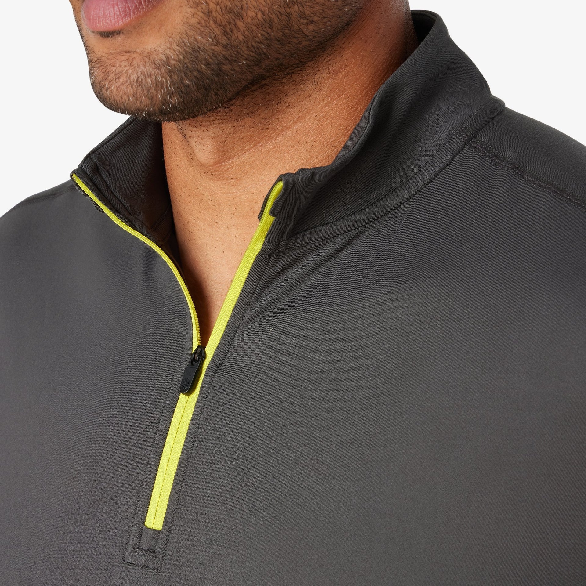 Black quarter zip pullover with neon yellow trim and half-zip closure, shown on male model.