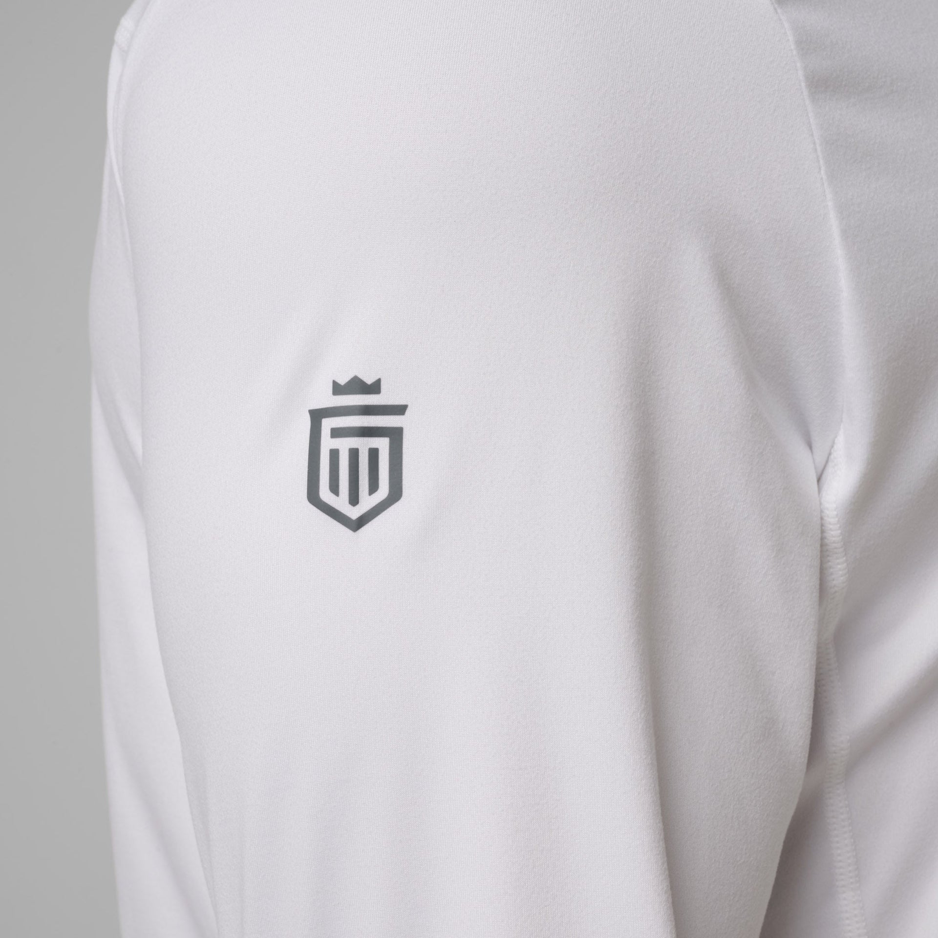 White quarter zip sweatshirt with gray shield logo on chest.