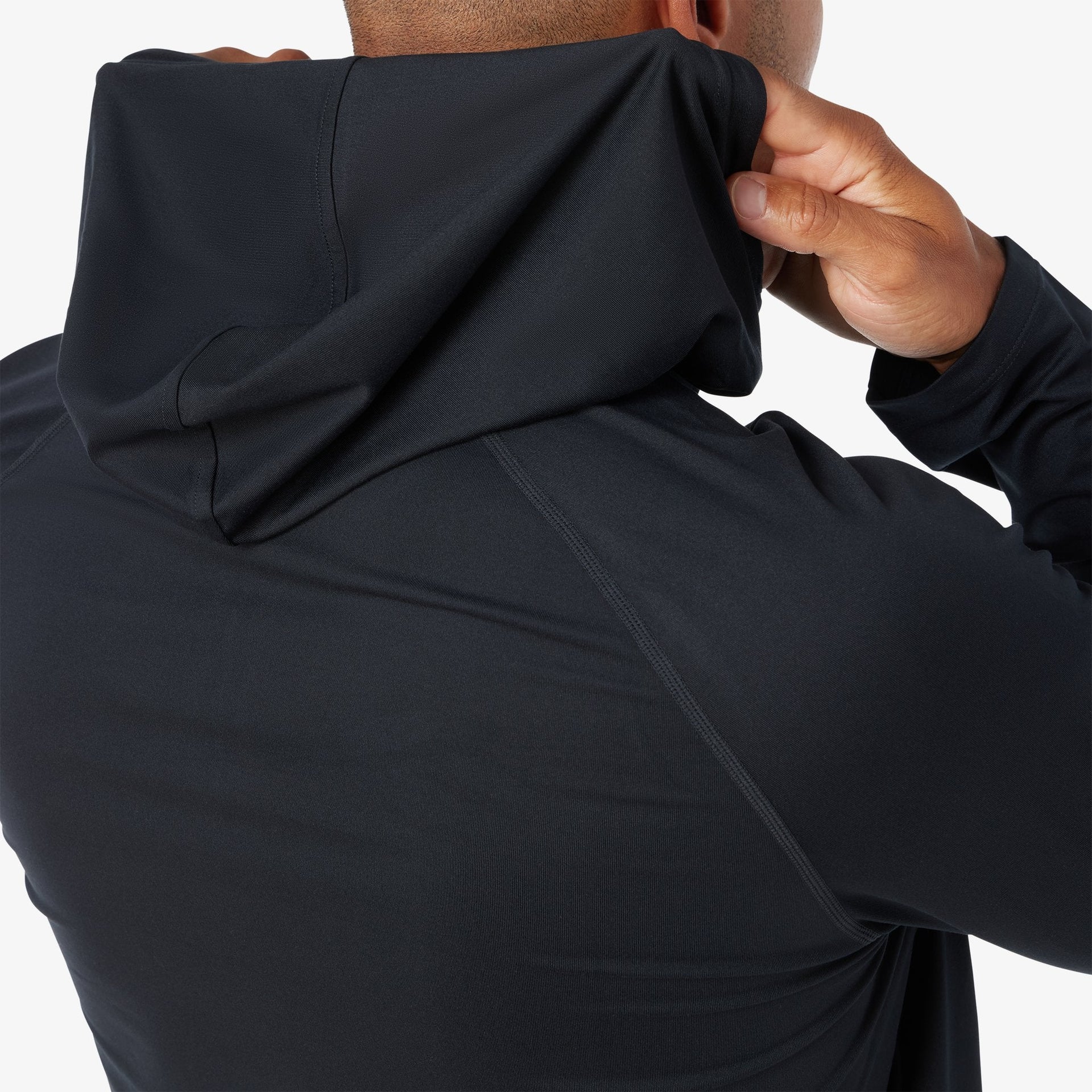 Black quarter-zip hoodie with kangaroo pocket worn by model, showing fabric texture and fit.