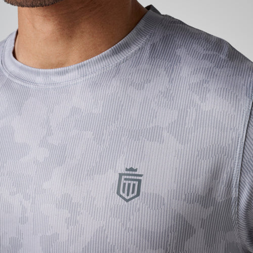 Light gray ribbed crew neck t-shirt with small shield logo on chest, worn by model.