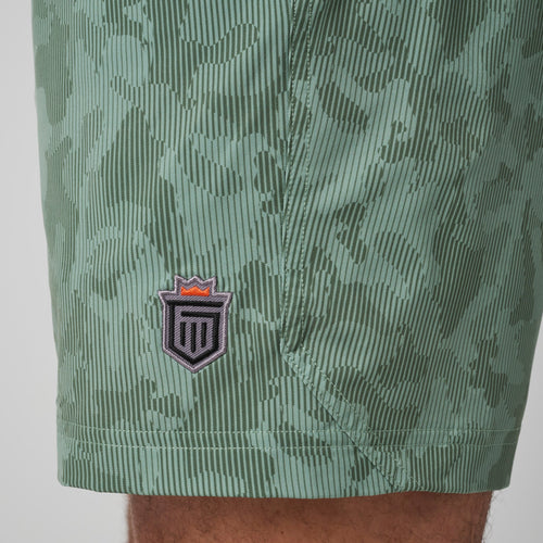 Sage green ribbed training short with embroidered shield logo on thigh.