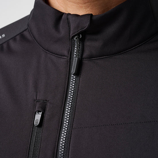 Black hybrid jacket with high collar and full-length metallic zipper closure.