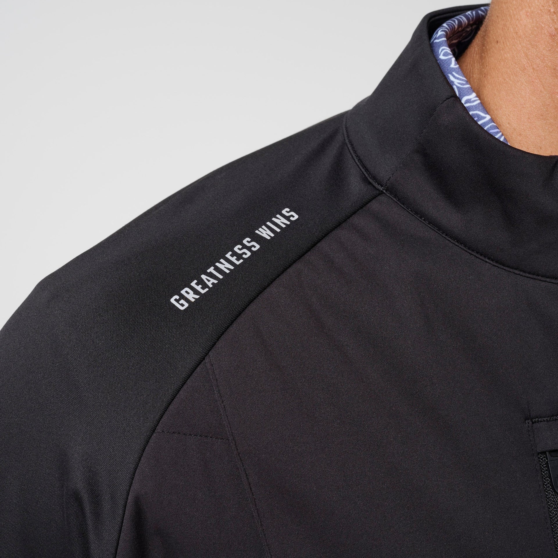 Black hybrid jacket with blue quilted lining visible at neckline and 