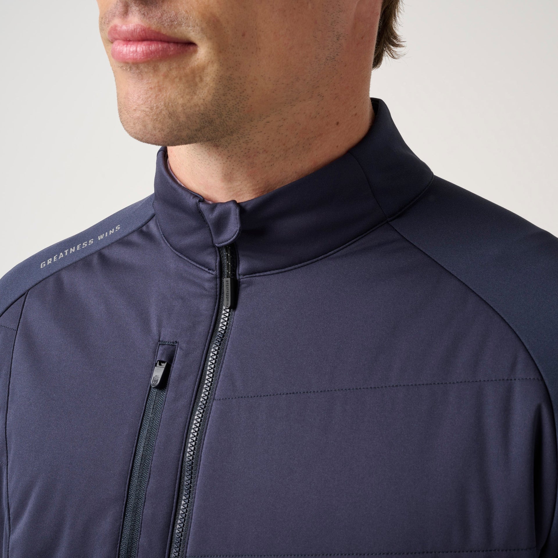 Man wearing navy hybrid jacket with full-length zipper and 
