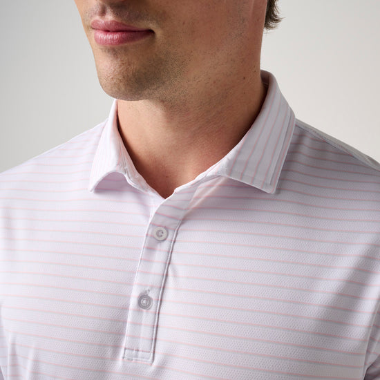 Man wearing light pink striped mesh polo shirt with collar and button front closure.