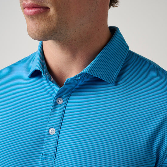 Man wearing bright blue striped polo shirt with collar and button front closure.